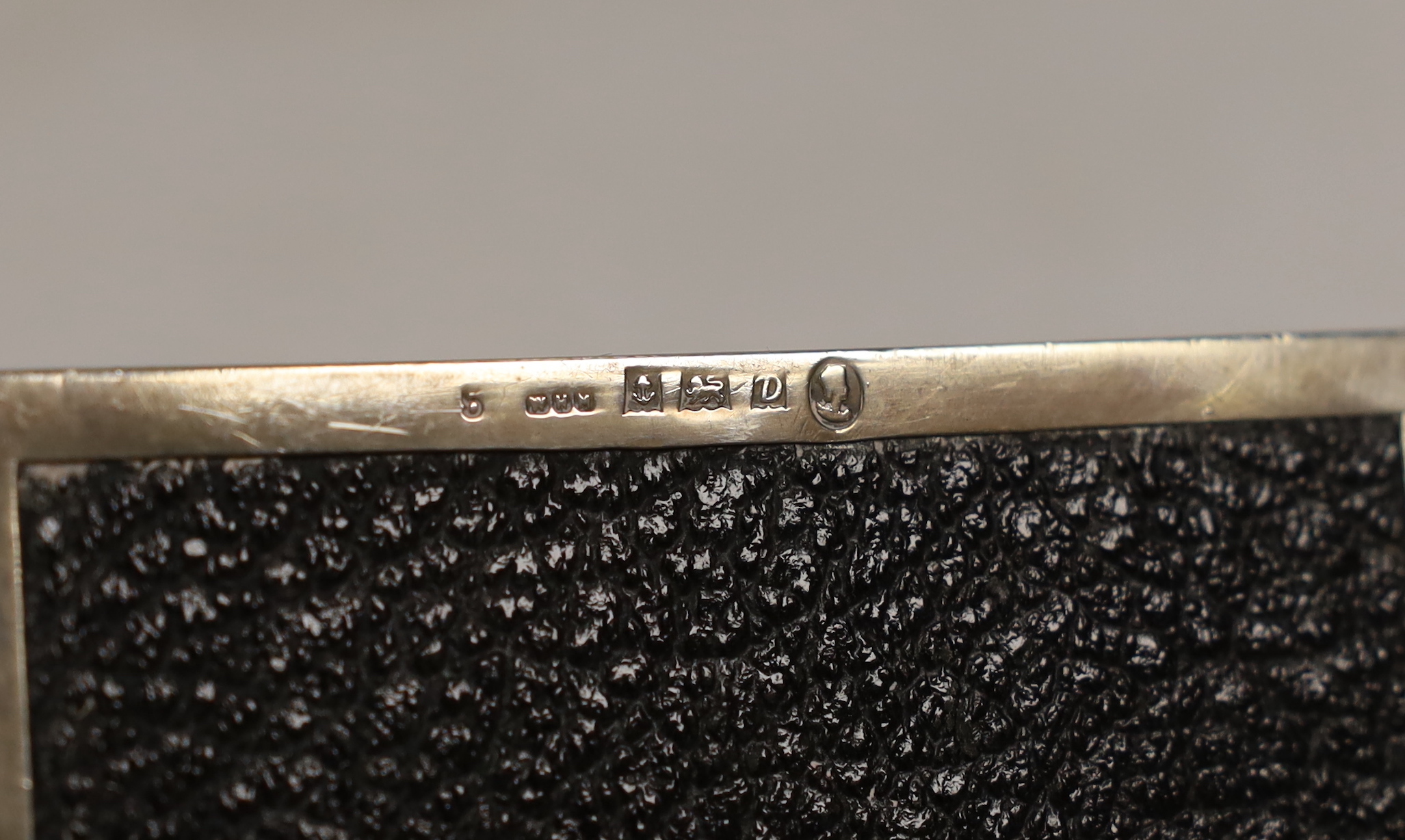 A 20th century part engine turned silver mounted cigarette box, 10.8cm, marks rubbed.